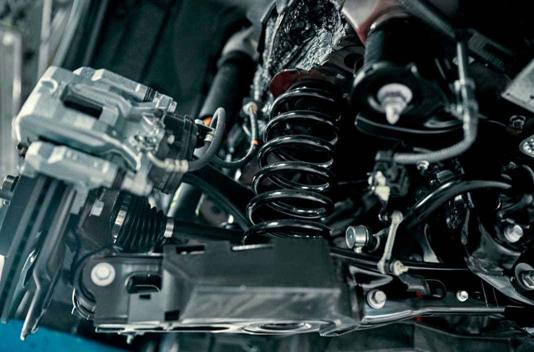 Car Suspension System During Repair Close-up of a car's suspension system, including coil springs and shock absorbers, undergoing professional suspension repair at Pulaski Automotive in Chicago.
