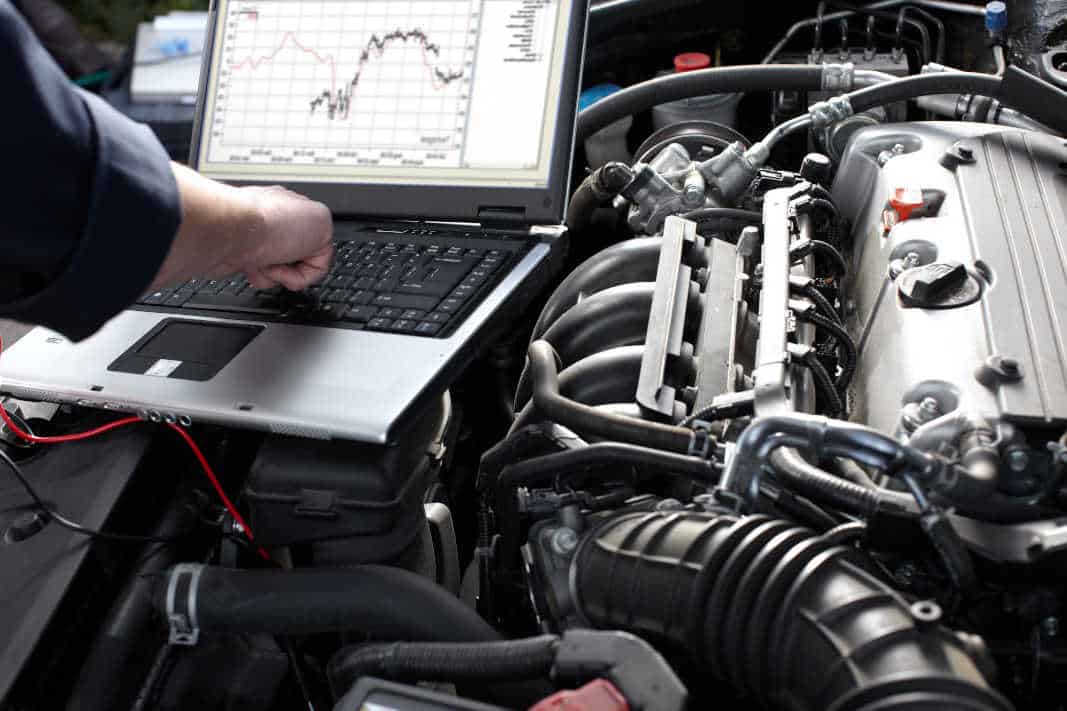 Engine Diagnostics with Advanced Tools Mechanic performing engine diagnostics using a laptop to analyze performance data and troubleshoot issues at Pulaski Automotive in Chicago.